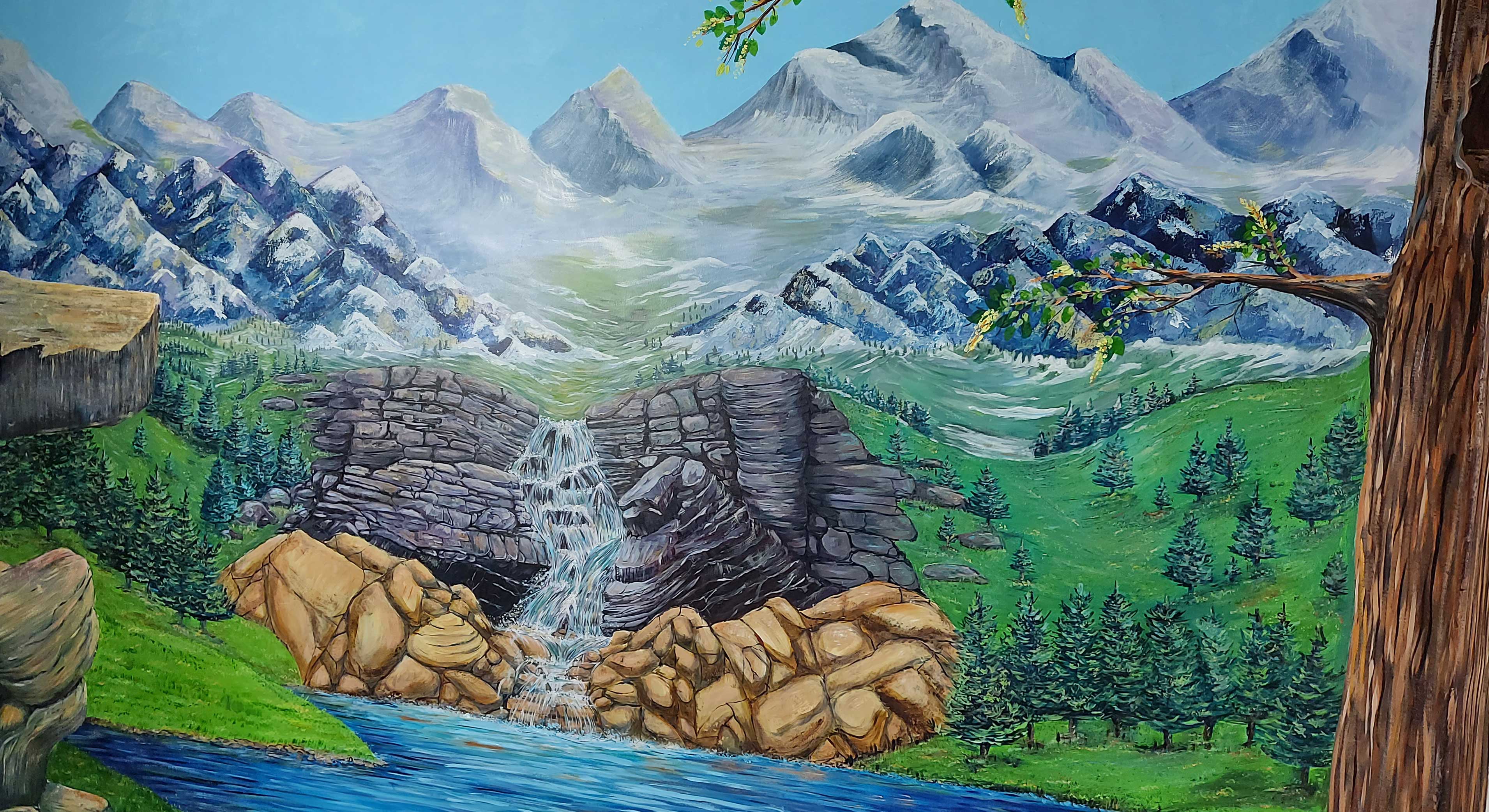 Image of a large landscape mural created by Ellie Jakeman, mountains, valley, trees waterfall and a lake.