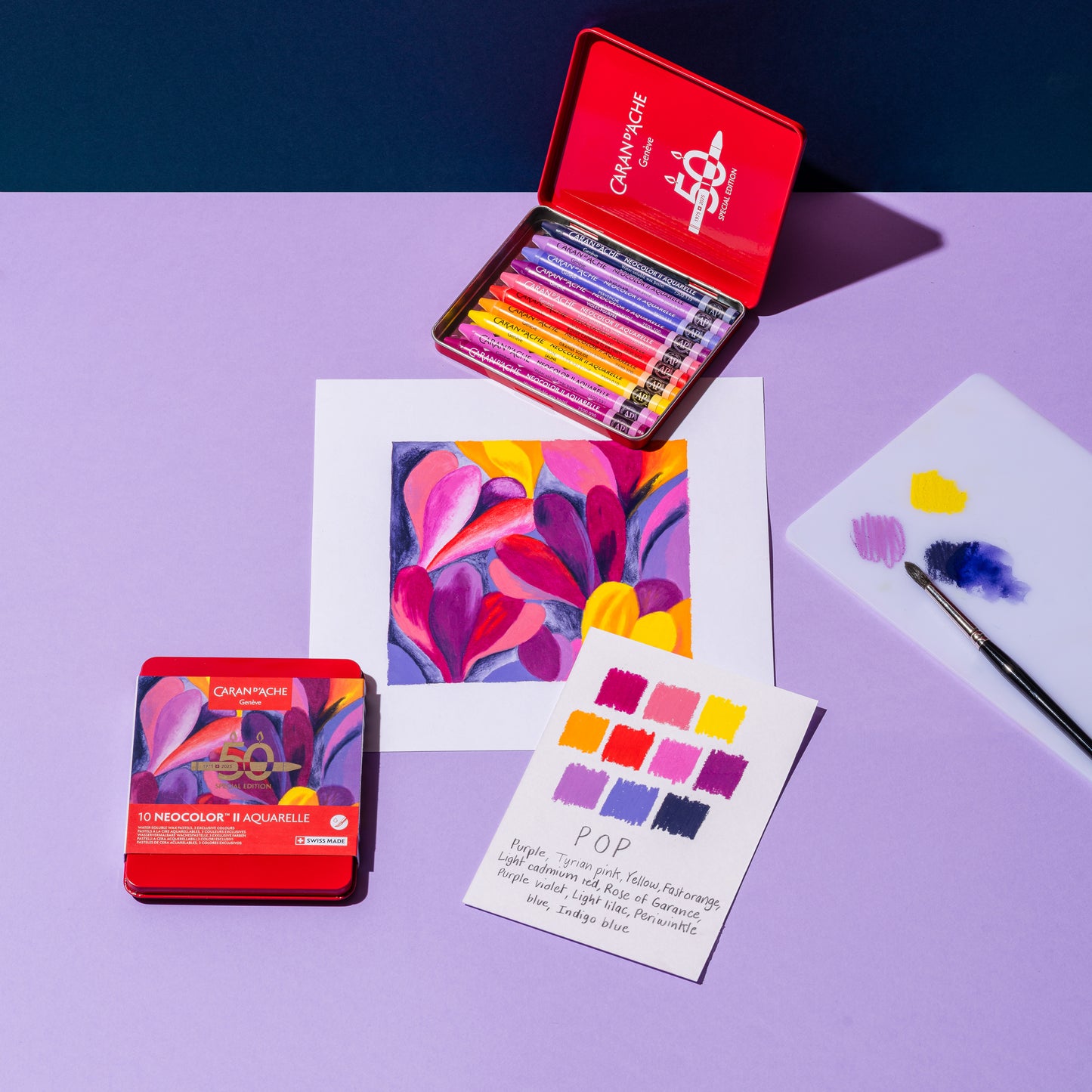 Chromatic art supplies with color swatches and a painting on a purple background