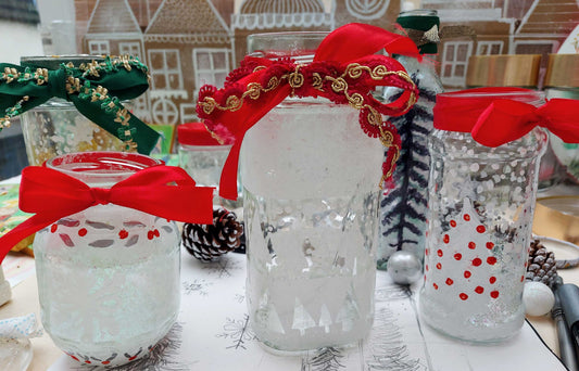 upcycled glass jars made into Christmas lanterns with fairy lights