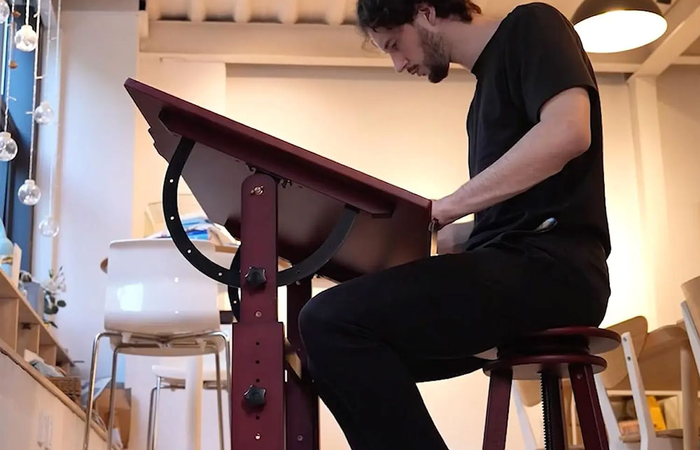 Artist stood at a Meeden Extra Large Wood Drafting Table Deep Walnut