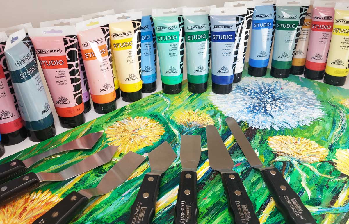 Artdiscount heavy body paint, a selection of colours in a line on top of a painting