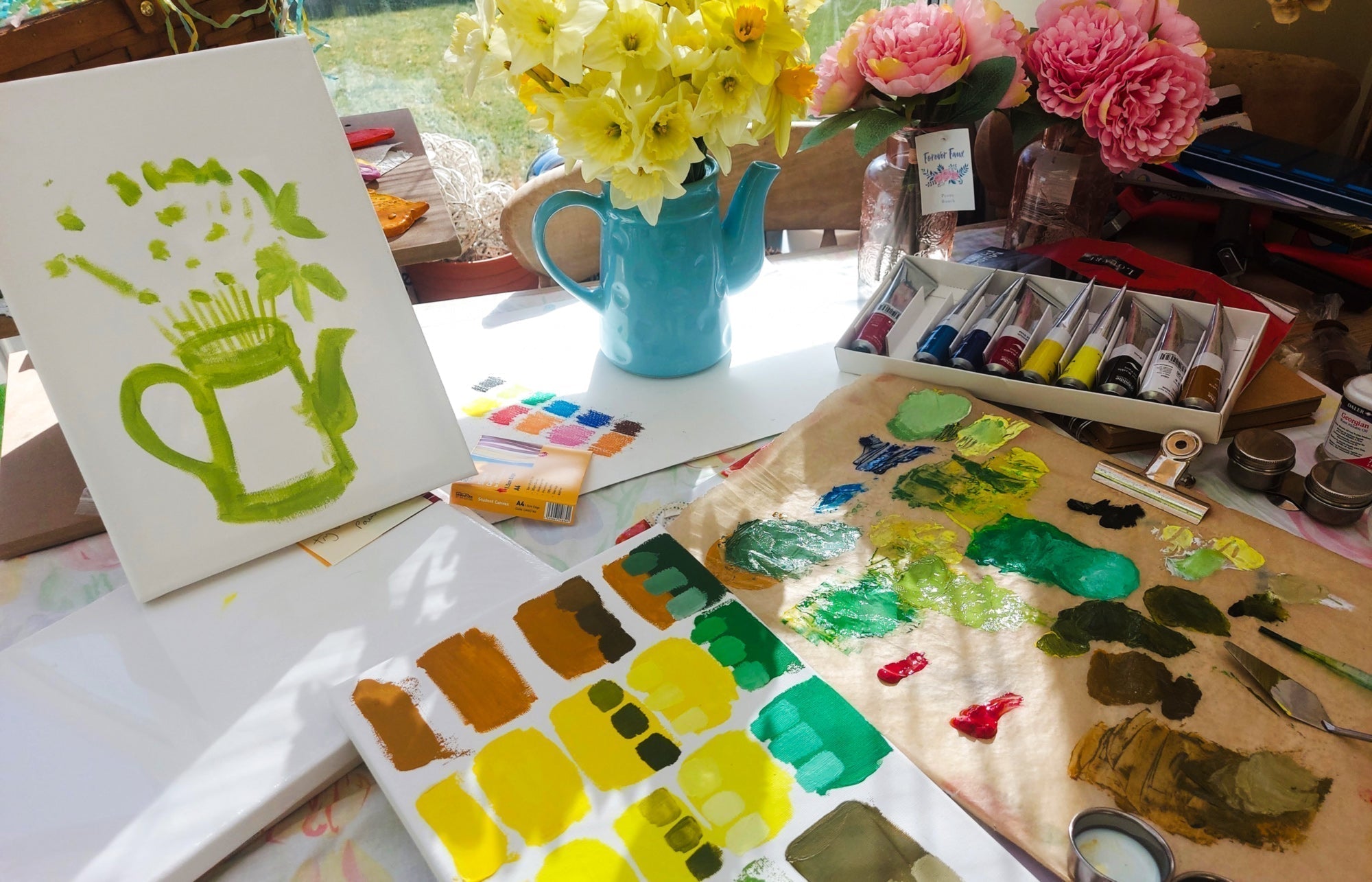 an image of a set of Water-Mixable Oil Paints and a canvas with the beginnings of a still life painting