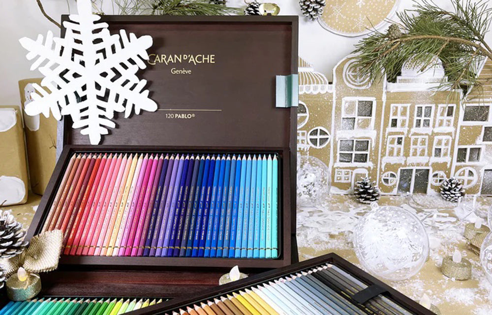 Beautiful crafted wooden box open, revealing 3 draws of coloured Caran d'Ache Pablo pencils.