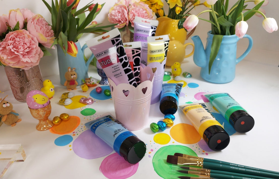 An Easter image, with Tea Pots and flowers, tubes of Studio Acrylic Paint in some pastel metal plant pots.