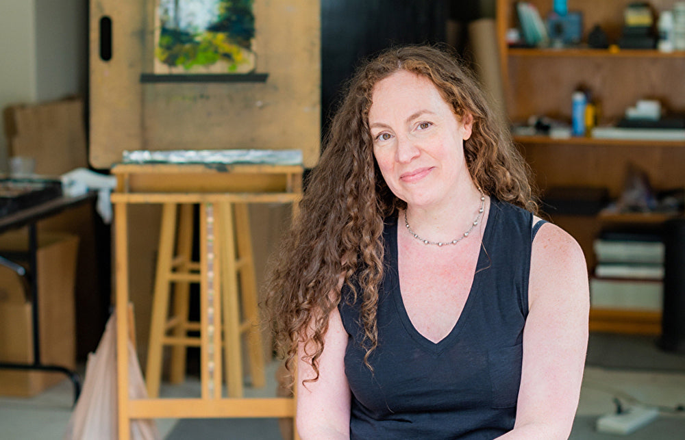 Artist Kim Eshelman sat in front of one of her soft pastel paintings.