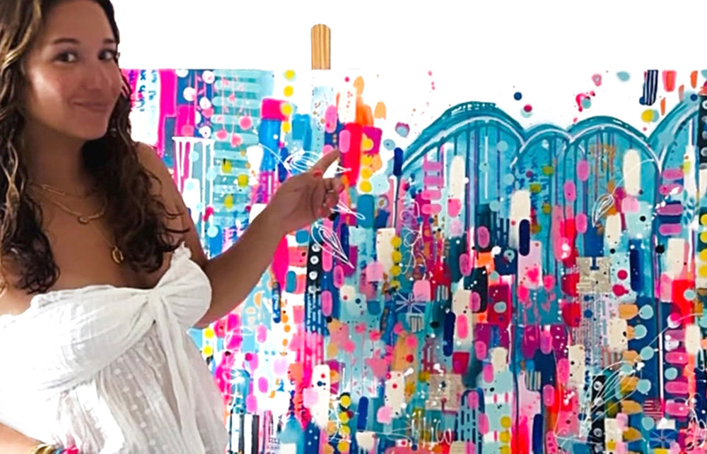 Photo of Norma Chung with her colourful abstract artwork