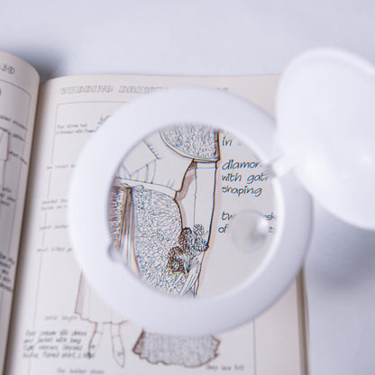 Daylight Halo Go 2 Lamp magnifying a dress design