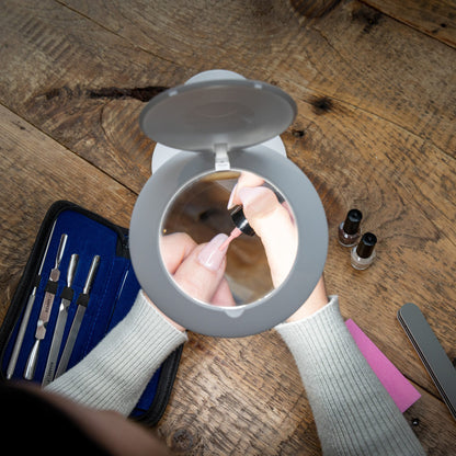 Daylight Halo Go 2 Lamp in use to magnify the application of nail polish